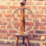 21593638-Spinning-in-vintage-style-on-a-brick-wall-Stock-Photo